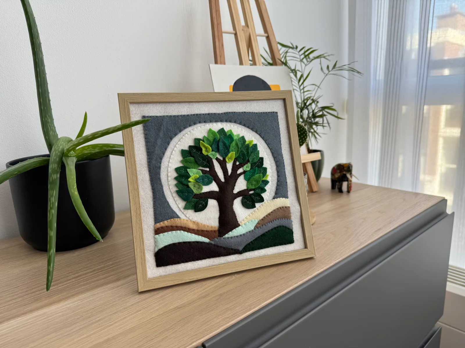 Finished felt landscape displayed at home